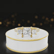 360-degree spinning view of a princess cut three-stone lab-grown diamond engagement ring in 18kt yellow gold with diamond shoulders