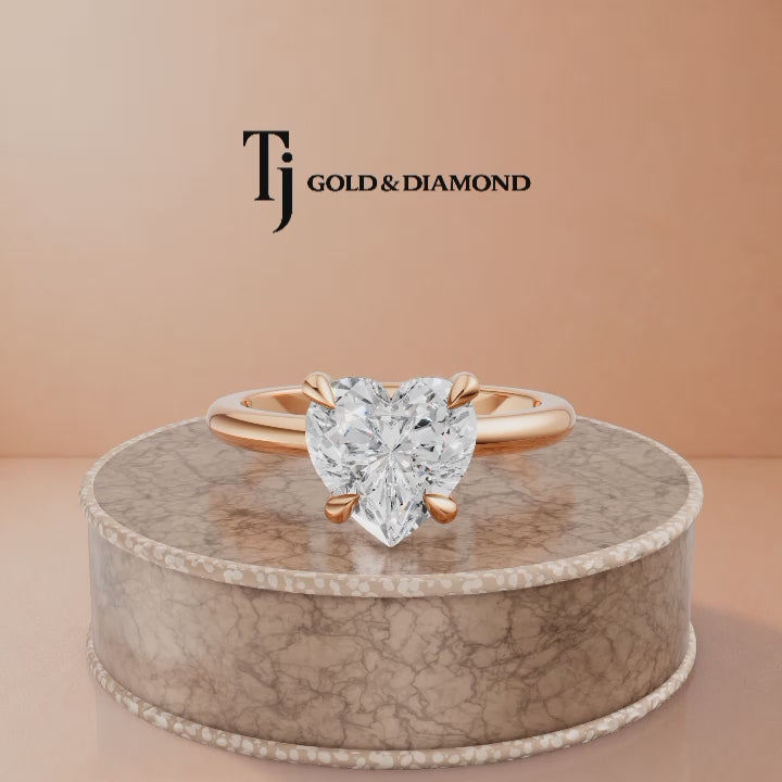 360-degree rotating view of a 1.5 carat heart cut lab-grown diamond solitaire engagement ring in 18kt rose gold with a 4-claw setting