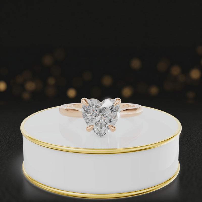 360-degree rotating view of a 1.5 carat heart cut diamond solitaire engagement ring in an 18kt rose gold 4 claw setting by TJ Diamond