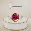 360° product view of an oval cut lab-created ruby trilogy engagement ring in 18kt yellow gold with oval lab-grown diamond side stones and a classic four claw basket setting.