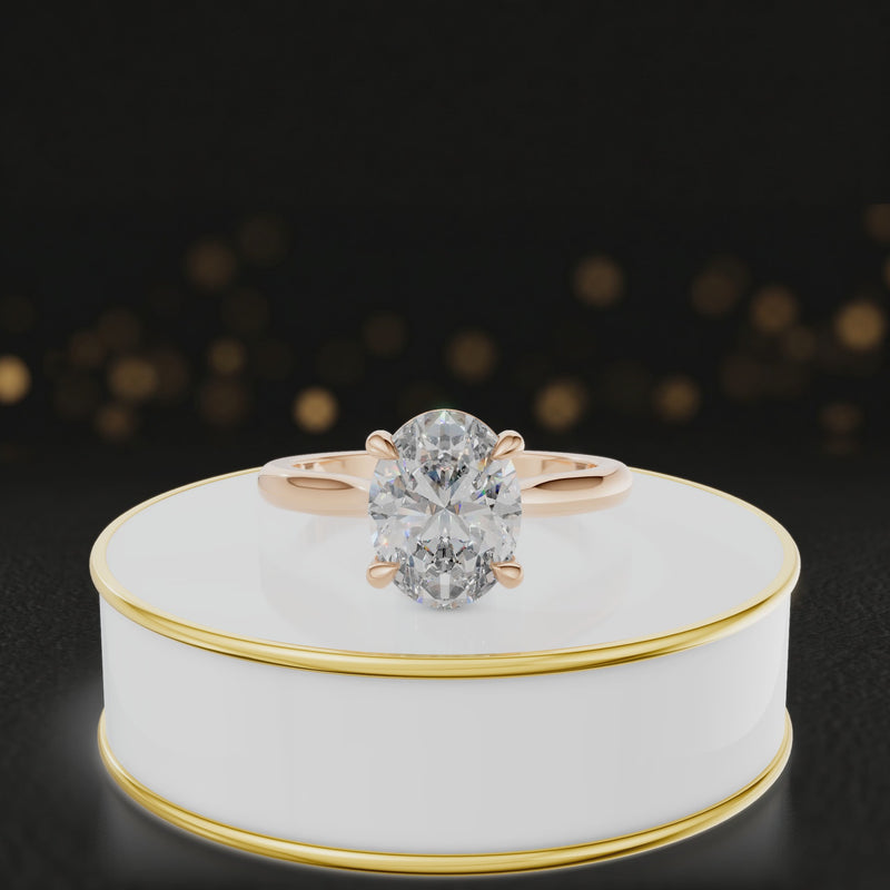 360-degree rotating view of a 1.5 carat oval cut diamond solitaire engagement ring in an 18kt rose gold 4 claw setting by TJ Diamond