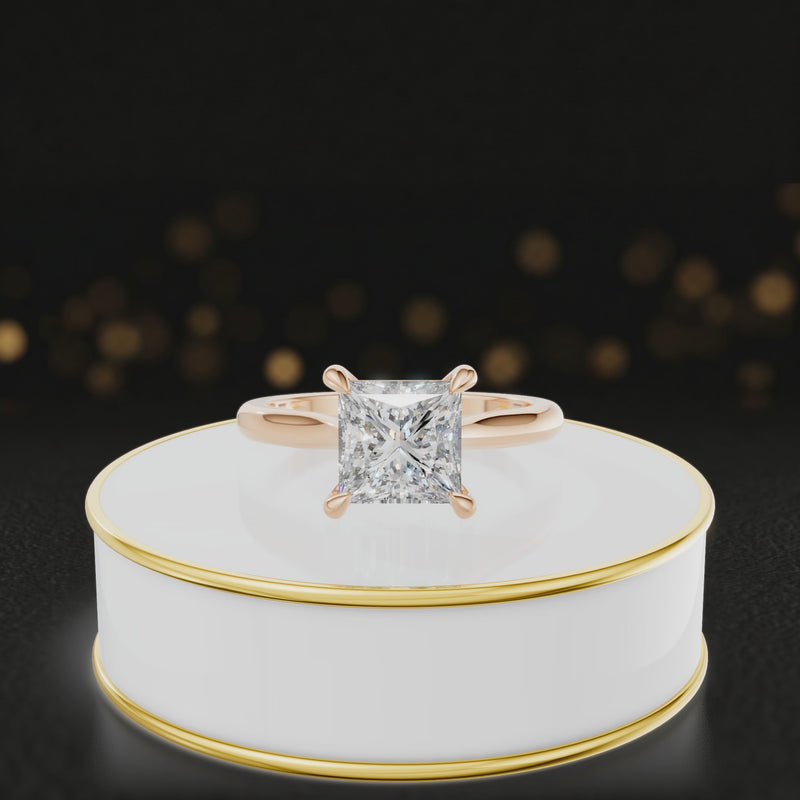 360-degree rotating view of a 1.5 carat princess cut diamond solitaire engagement ring in an 18kt rose gold 4 claw setting by TJ Diamond