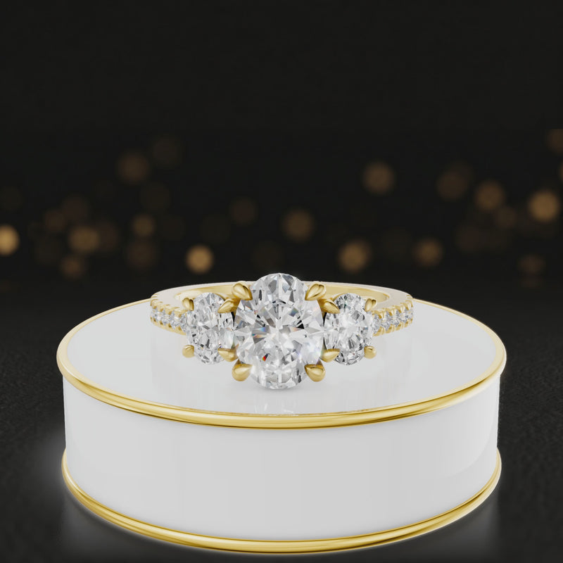 360-degree spinning view of an oval cut three-stone lab-grown diamond engagement ring in 18kt yellow gold with diamond shoulders