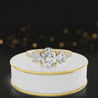 360-degree spinning view of an oval cut three-stone lab-grown diamond engagement ring in 18kt yellow gold with diamond shoulders