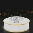 360-degree rotating view of a cushion cut three-stone diamond engagement ring in 18kt white gold with diamond shoulders