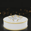 360-degree spinning view of a pear cut three-stone lab-grown diamond engagement ring in 18kt yellow gold with diamond shoulders