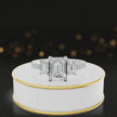 360-degree rotating view of an emerald cut three-stone lab-grown diamond engagement ring in 18kt white gold with diamond shoulders