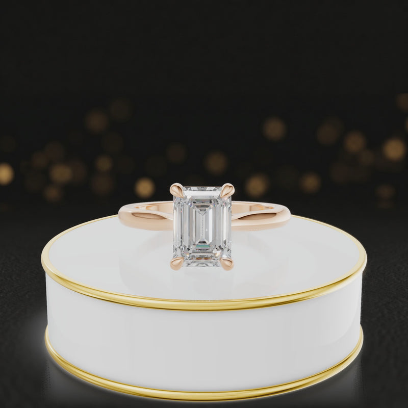 360-degree rotating view of a 1.5 carat emerald cut diamond solitaire engagement ring in an 18kt rose gold 4 claw setting by TJ Diamond