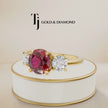 360° product view of a round brilliant lab-created ruby trilogy engagement ring in 18kt yellow gold with round brilliant lab-grown diamond side stones and a classic four claw basket setting.